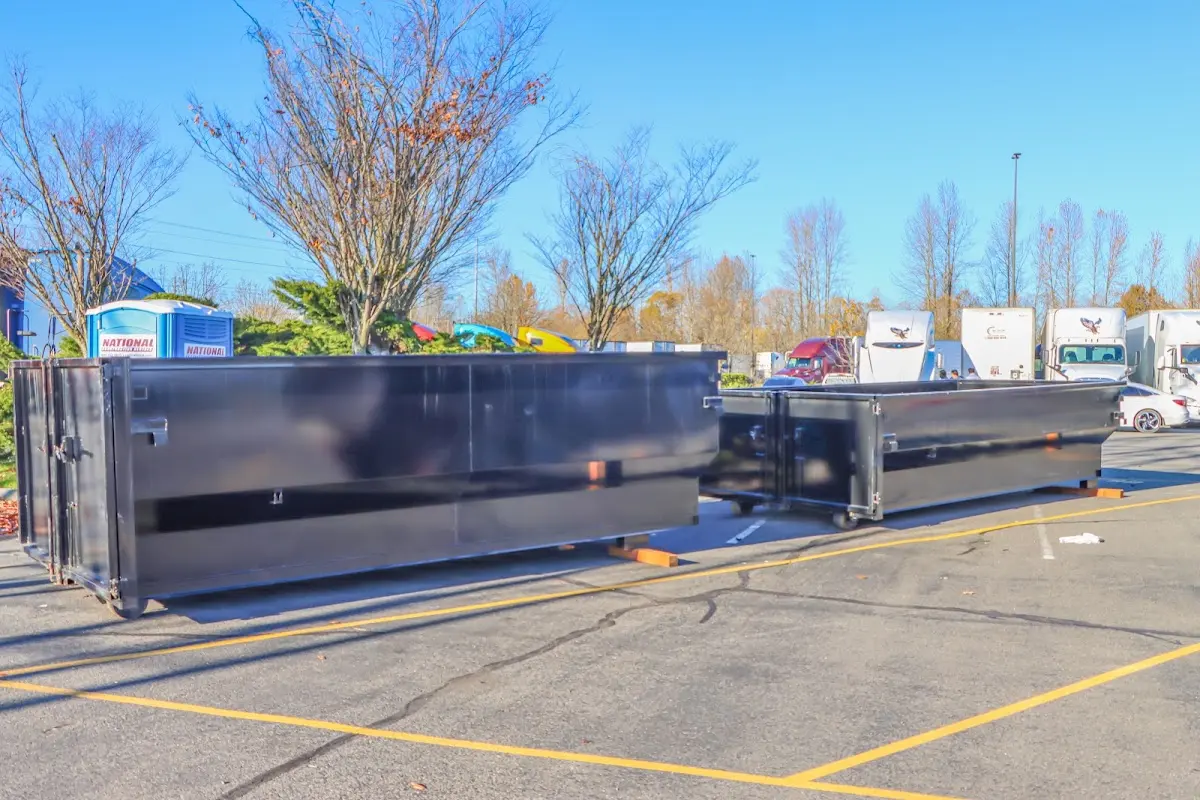 Professional dumpster rental service with roll-off container on residential driveway in Sayreville